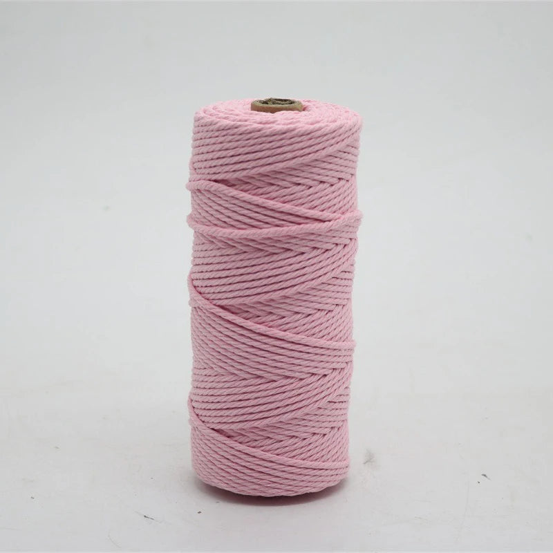 Pink macrame cord in a spool for crafting