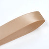 A beige satin ribbon roll is shown in a side profile view.