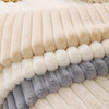A close-up of a cozy plush anti-slip sofa cushion mat featuring horizontal stripes in cream, beige, and gray faux fur.