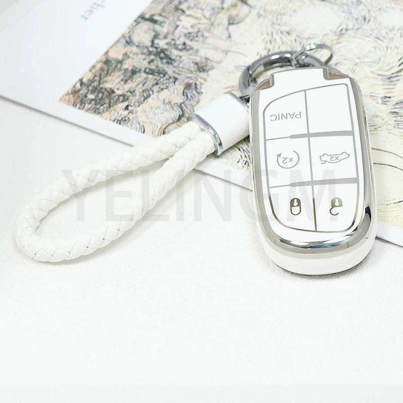 Silver key fob with panic button and lock buttons attached to a white cord