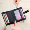 A hand is showing an RFID shielded bi-fold credit card wallet with several cards inside.