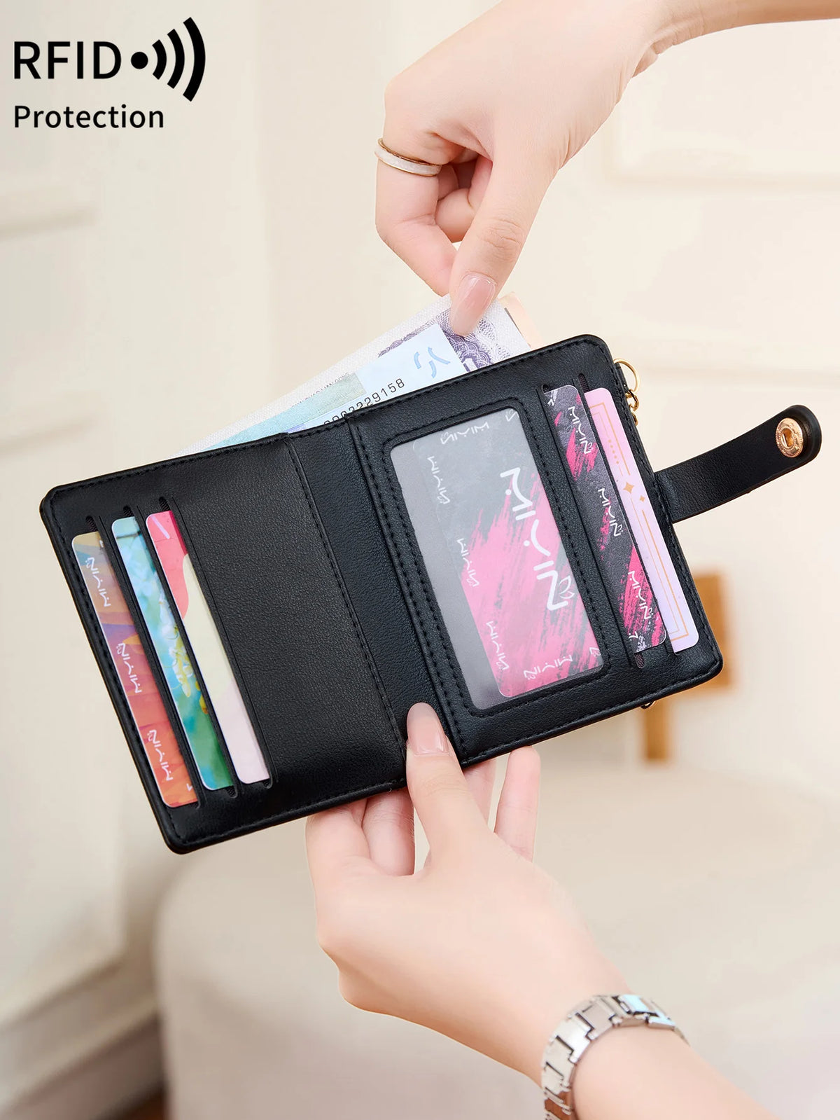 A hand is showing an RFID shielded bi-fold credit card wallet with several cards inside.