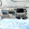 A gray car sun visor organizer holding cash, cards, a smartphone, and sunglasses.