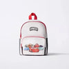 White backpack with a red strap and a graphic print on the front.