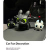 Three black and white Toothless-inspired resin car decorations with movable wings displayed on a gray surface.