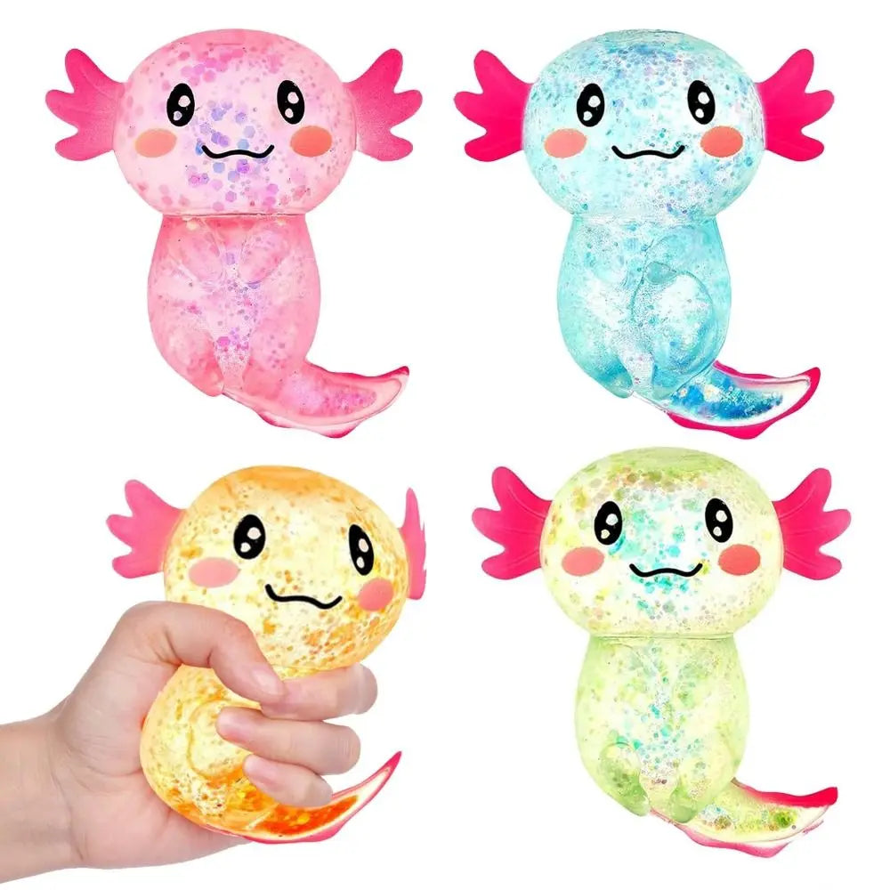 Trois jouets anti-stress souples et colorés d'axolotls, roses, bleus et jaunes.