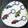 A set of four Ford Bronco zinc alloy keychains in red, blue, yellow, and black are displayed on a white plate.