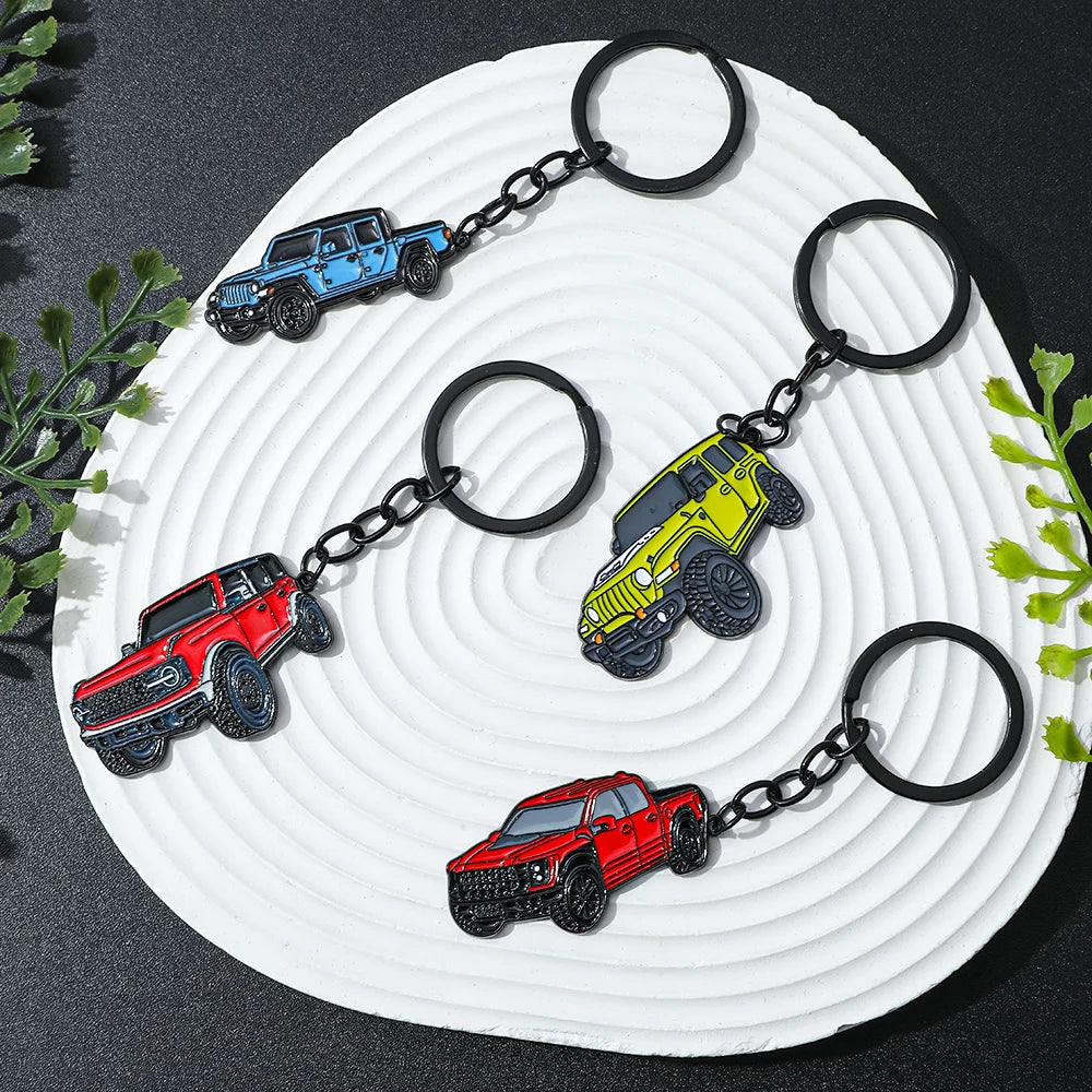 A set of four Ford Bronco zinc alloy keychains in red, blue, yellow, and black are displayed on a white plate.