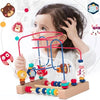 A child is playing with a wooden bead maze toy featuring colorful beads and strings.