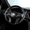 Interior view of a car steering wheel covered with ultra-thin carbon fiber material.