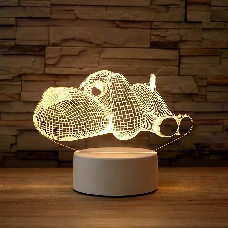A glowing wireframe 3D illusion LED night light lamp shaped like a rhinoceros resting on a wooden surface.