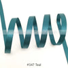 A teal satin ribbon is shown coiled and unwound against a white background.