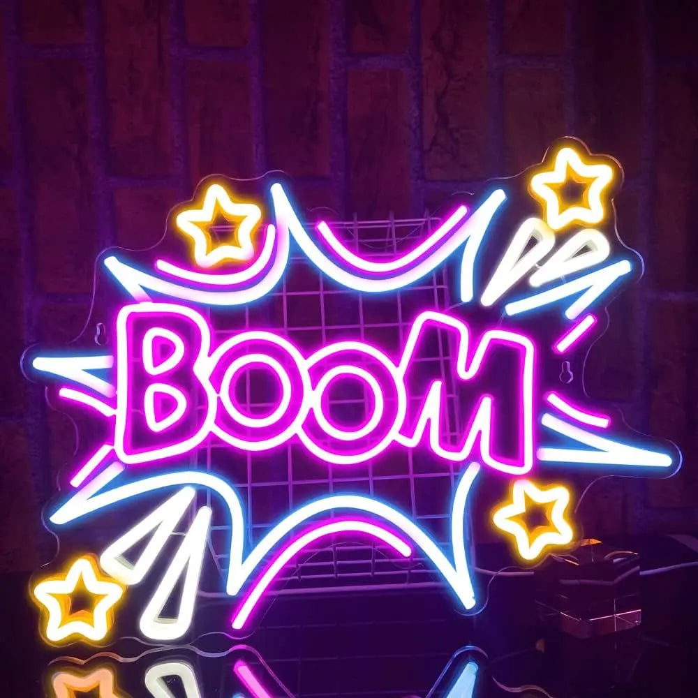 A neon sign shaped like the word BOOM in bright pink and blue light, displayed against a dark background.