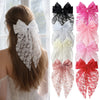 A collection of elegant lace bows for hair accessories in black, white, pink, and red.