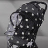 Black mosquito net cover with white floral patterns for a baby stroller or crib.