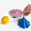 Hand holding a purple 3D illusion fidget star toy with various colored spiral patterns.