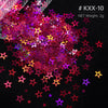 A pile of shiny holographic star sequins in various colors like pink, purple, and yellow on a black background.