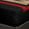 A black fitted sheet set with a red accent stripe and a patterned fabric visible on the edge.