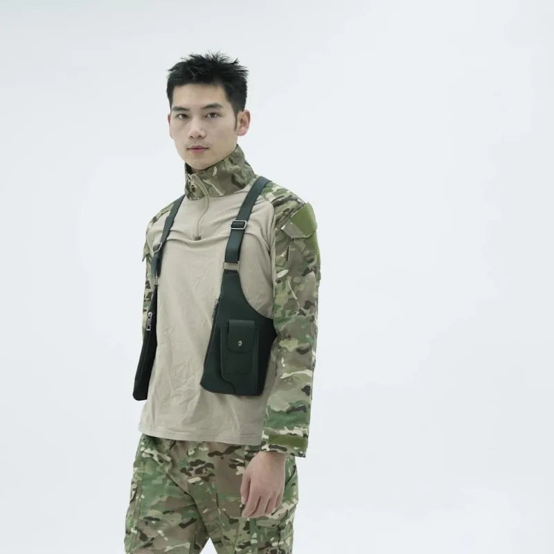 A male model wearing a camouflage shirt and olive green underarm wallet bag with an adjustable strap.