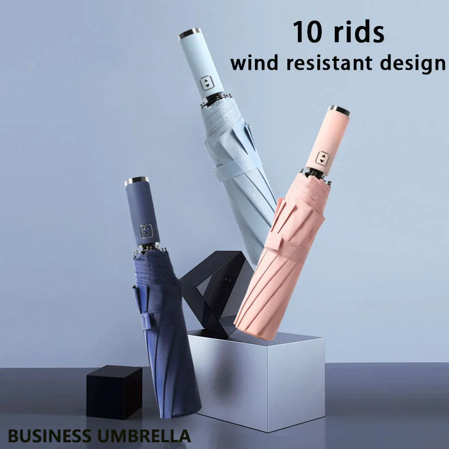 Ten wind resistant business umbrellas in various colors displayed upright in a box.