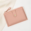 A pink women's slim PU leather card holder wallet with a stitched flap and leather pull tab.