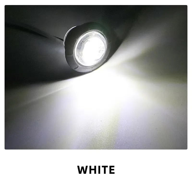 A close-up photo of a bright white round LED side marker light shining forward.