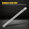 A stainless steel ruler showing markings up to 40 cm, lying diagonally on a dark surface.