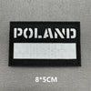 A black rectangular patch with white text reading POLAND on a gray background.