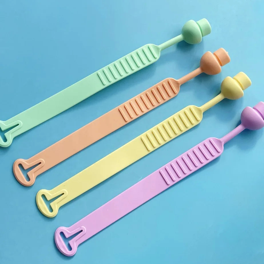 A set of silicone toilet seat lifters in pastel colors, including green, peach, yellow, and purple.