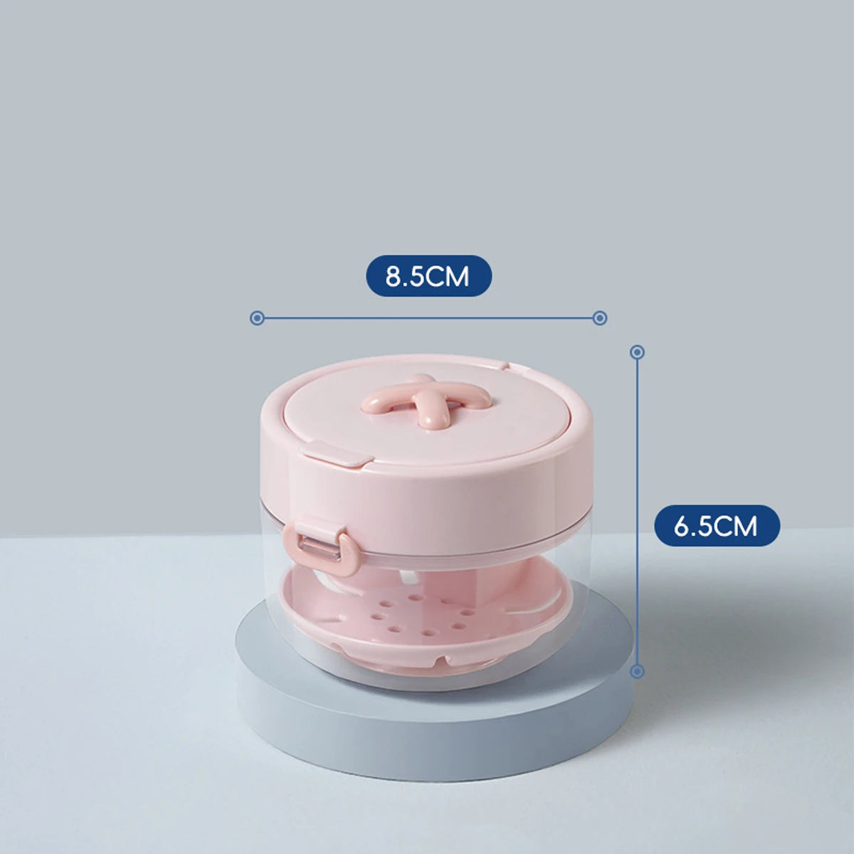 A pink portable denture case with a lid and cleaning brush storage, shown from the top view.