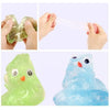Hands are squeezing green stress putty, and a light-colored putty is being stretched between two hands.