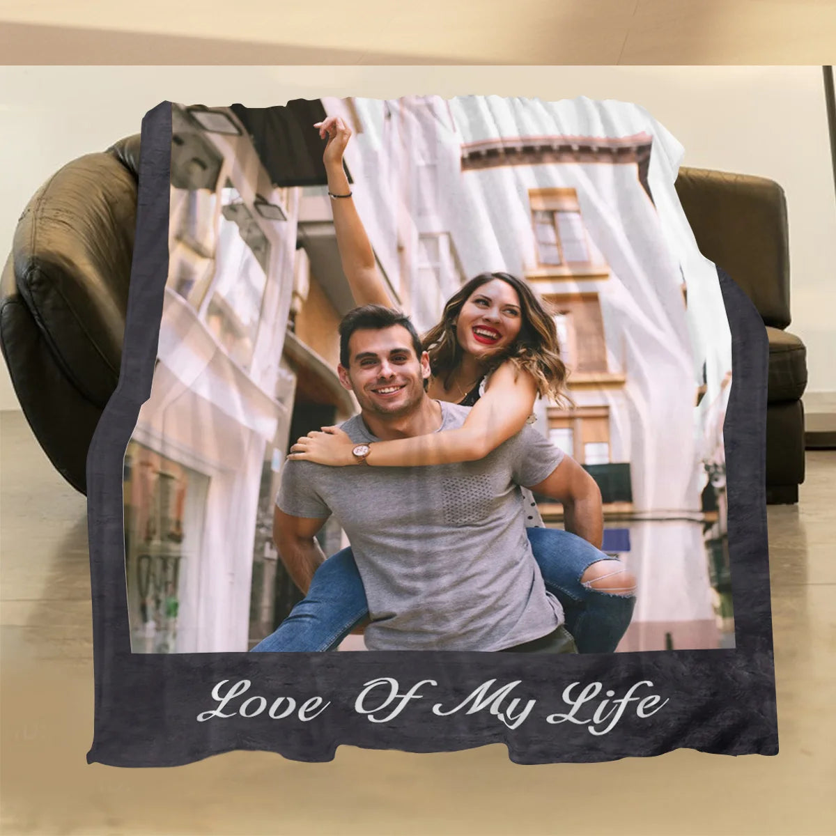 A photo blanket featuring a couple smiling, framed by a dark border and the text Love Of My Life.