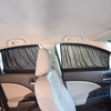 Interior view of a car seat showing a black fabric sun shade covering the side window.