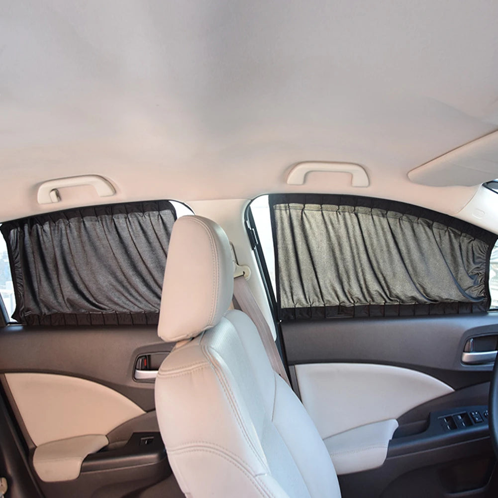 Interior view of a car seat showing a black fabric sun shade covering the side window.