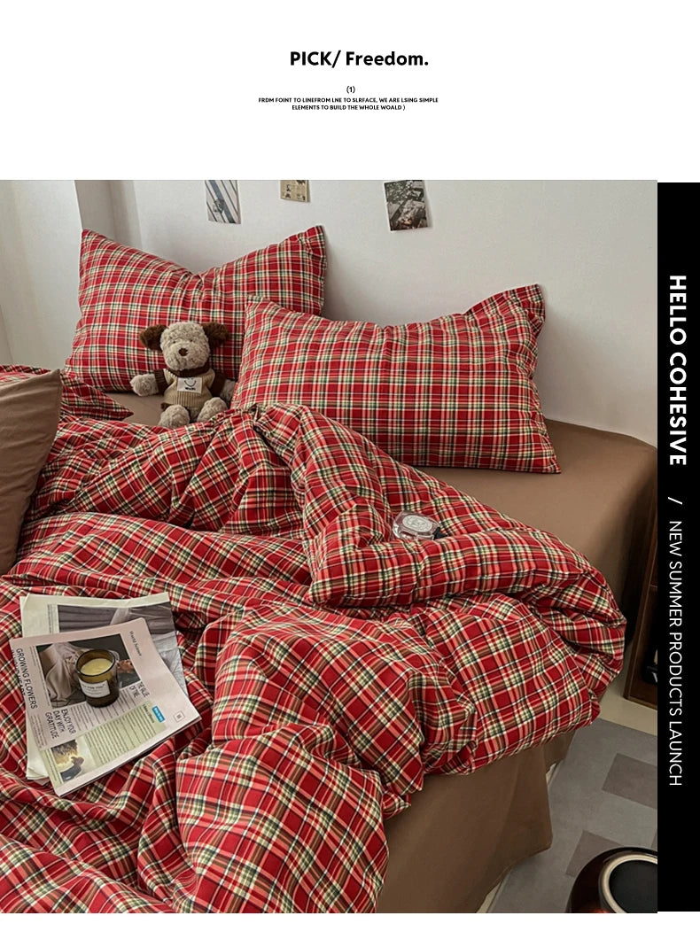 A close-up of a red plaid duvet cover set featuring a classic tartan pattern on a bed.