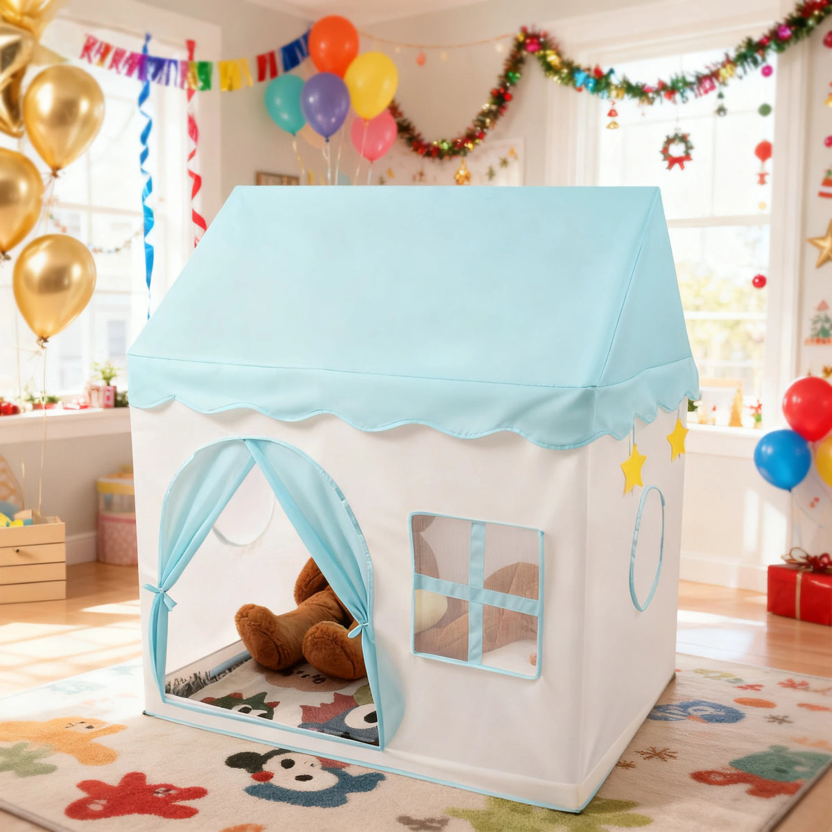 A white playhouse tent with a light blue roof and arched entrance, decorated with balloons and festive garlands.