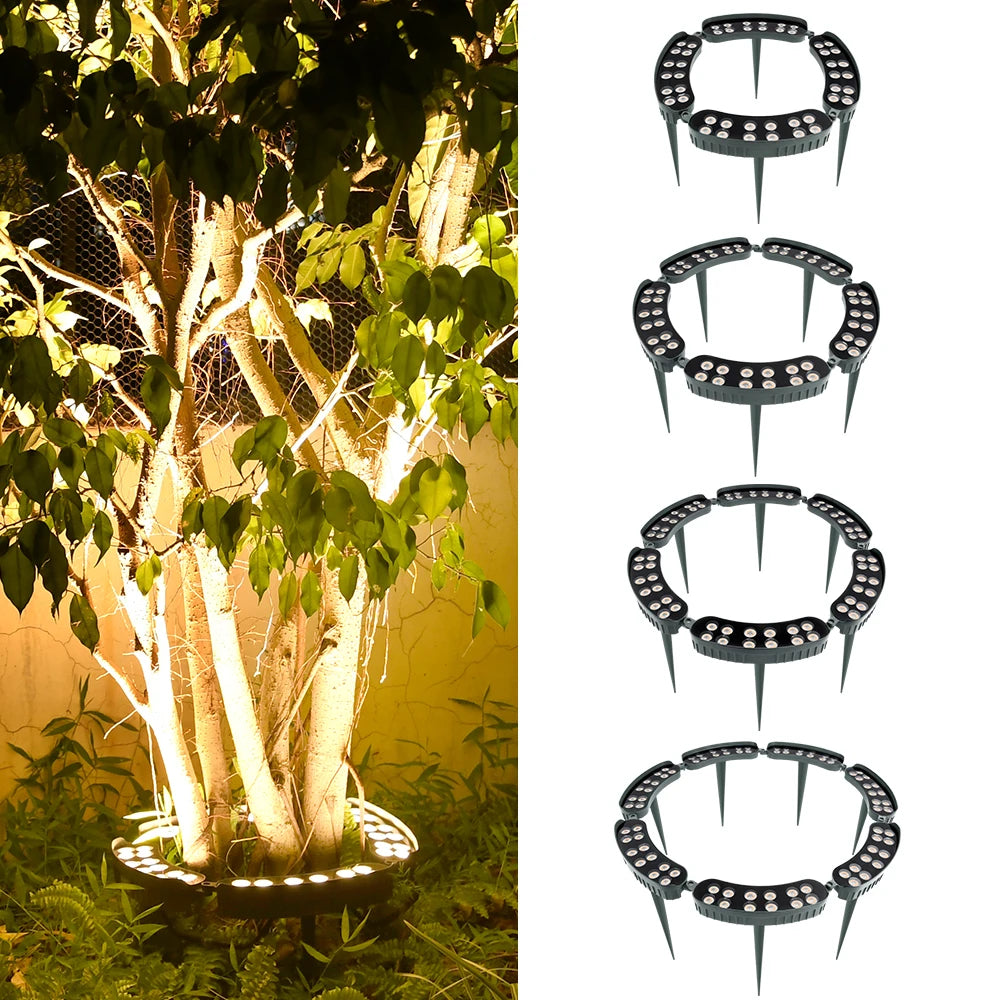 A tree is illuminated by a ground spike LED light, highlighting its bark and foliage.
