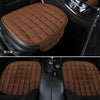Close-up view of a brown quilted plush car seat cover placed on a black car seat.