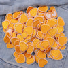 A cluster of orange and cream heart-shaped embroidered iron-on patches on a denim fabric.