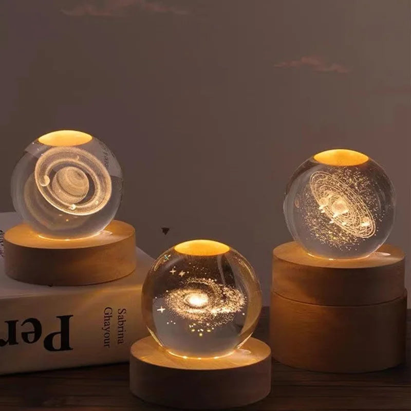 Laser engraved crystal ball night light with a swirling pattern on a wooden base