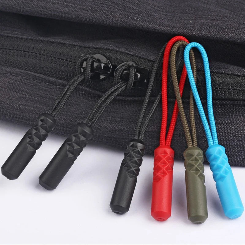 A set of replacement zipper pulls with nylon cords in various colors including black, red, olive green, and blue.