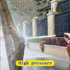A hand sprays a powerful stream of water from a high-pressure gun onto a tree trunk.