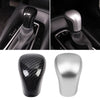 Carbon fiber gear shift knob covers in black and silver for Toyota Camry and Corolla vehicles