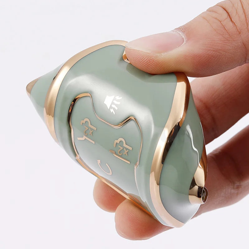 A hand holds a light green TPU smart key fob cover with a gold trim and an etched logo.