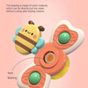 A close-up view of a plastic bee-shaped bath toy with a rotating bearing mechanism.