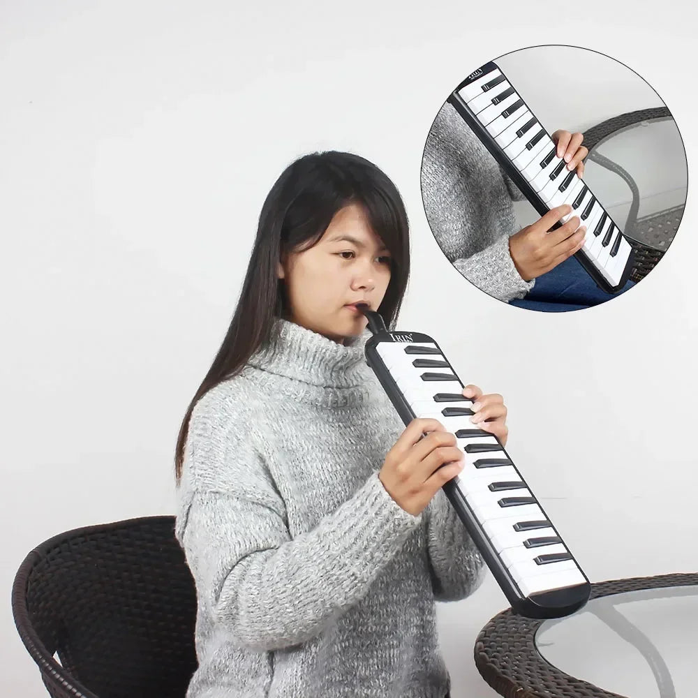 A woman is playing a black 32-key melodica with a case and mouthpieces, shown alongside an inset diagram.