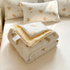 A set of cream and yellow breathable summer duvet covers with a lace trim and bear embroidery.