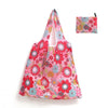 A pink floral reusable shopping tote bag with a matching small pouch.