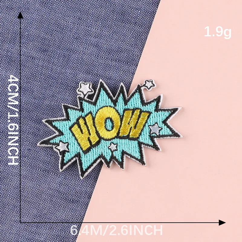 A yellow and blue embroidered lettering patch shaped like WOW on a denim fabric background.