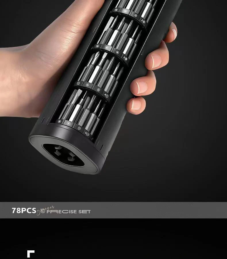 A hand holds a black precision screwdriver set with multiple screwdriver bits inside the magnetic case.